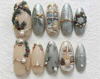 May include: A set of ten almond-shaped press-on nails featuring holiday designs. The nails are decorated with painted pine branches, red berries, gold stars, snowflakes, wreaths, and candles in windows, accented with small white pearls and gold lines.