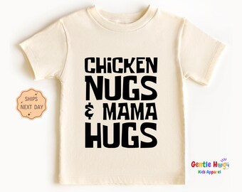 May include: A cream colored t-shirt with black text that reads "Chicken Nugs & Mama Hugs".