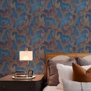 May include: Wallpaper featuring a repeating pattern of blue horses on a mottled background of brown, purple, and green. The horses are depicted in a stylized, artistic manner. The wallpaper covers the wall behind a bed with pillows and a wooden headboard.