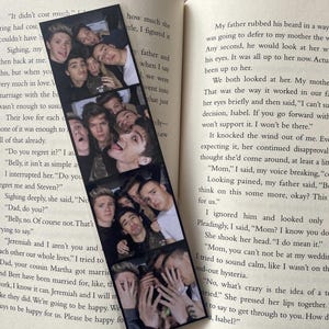May include: A black and white photo bookmark featuring a group of young men smiling and posing for a photo. The bookmark is made of thick cardstock and has a glossy finish.