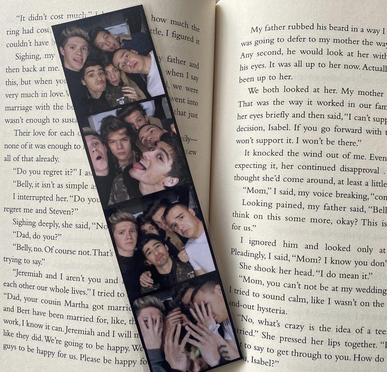 May include: A black and white photo bookmark featuring a group of young men smiling and posing for a photo. The bookmark is made of thick cardstock and has a glossy finish.