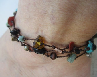 Anklet Gemstone Mixes Glass,Metal and Wood beads. Three strand hand knotted on Brown Cord. Waterproof. Adjusts in Size from 10 "up to a 14".
