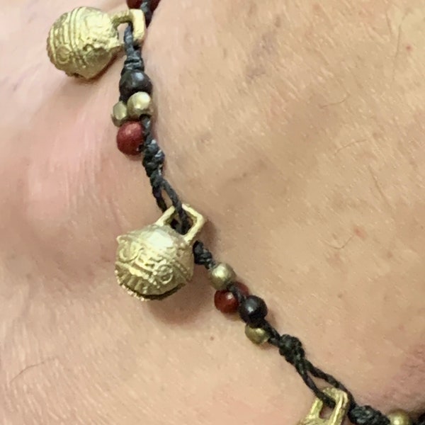 Tibetan Anklet Bhutan Temple Bells. Knotted Black cord.Brass Bells with tiny red, brass and wood beads. Size adjusts. Waterproof.Bells ring.