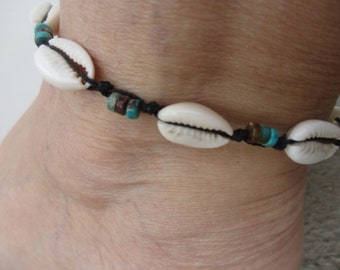 Anklet Cowrie Shells and Turquoise Heishe Gemstone Beads. Hand Knotted on Black Cord. Adjusts in size from 9"- 15". Waterproof. Non Metal.