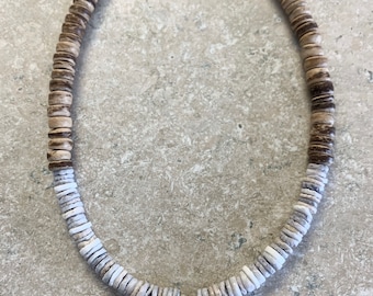 Puca Coconut Shell Necklace. Blue puca Shell and natural coconut beads. Cowrie Shell pendant center. Measures 15.5” with a 1.5” extend chain