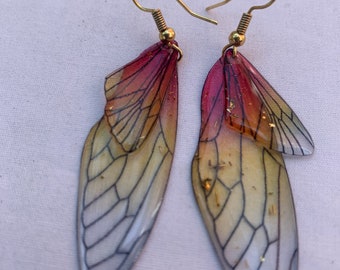 Butterfly Earrings. Acrylic with golden speckles added. Red, orange and yellow tones of brilliant colors. Measures 2.5 inches L. and , 1” W.