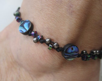 Shell Anklet. Paua Shell of 1/2” size circular beads. Hand Knotted on Black Cord. Adjusts 10"-13".. Waterproof. Size adjusts 7” up to 10”.