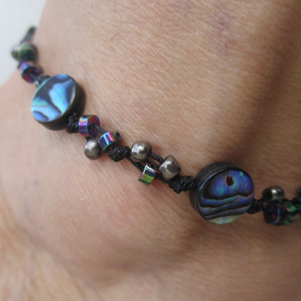 Shell Anklet. Paua Shell of 1/2” size circular beads. Hand Knotted on Black Cord. Adjusts 10"-13".. Waterproof. Size adjusts 7” up to 10”.