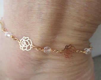 Anklet Chain gold plated with filigree roses and white wire wrapped crystal beads. Anklet Adjusts in size from a 9.5" up to a 10.5".