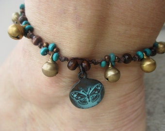 Anklet Butterfly painted antiqued brass with wood beads and india brass bells. Hand knotted on brown cord that adjusts in size 9.5" to 11.5"