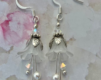 Flower Earrings. Frosted White Lucite flower petals. Genuine Swarovski Crystals. Silver plated Ear Wires and components. Just over 2” length