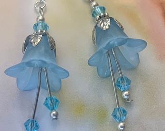 Flower Earrings. Baby blue frosted lucite. Genuine Swarovski Crystals and Silver hook ear wires and components Drop length is 2 1/4”