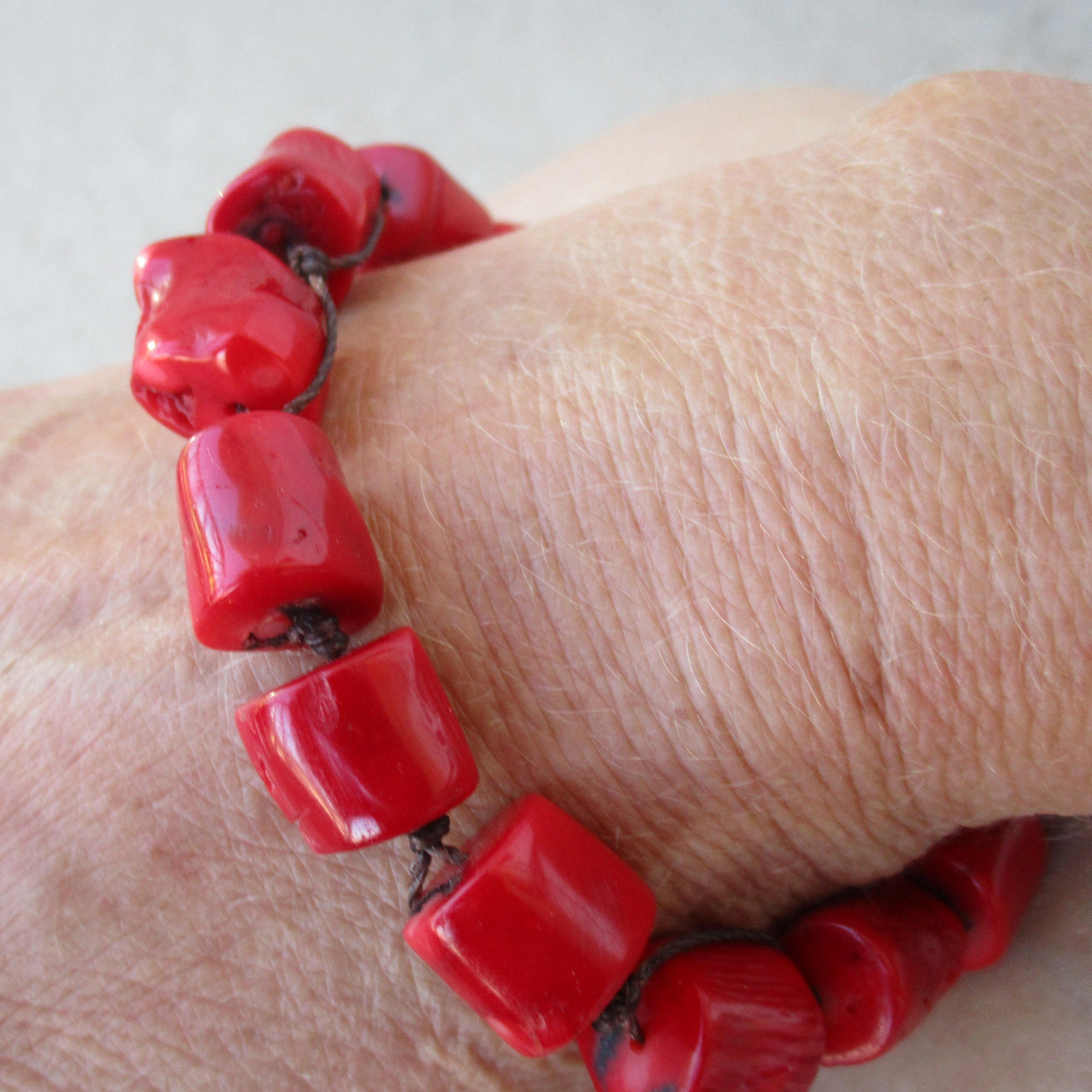 Red Coral Bamboo Bracelet Uni Sex. Hand Knotted on a Brown Cord