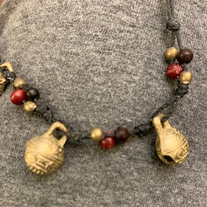 Tibetan Anklet. BhutanTemple Bells. Hand Knotted on Black cord. Brass Bells with choice of bead color (specify)Size adjusts. Waterproof.