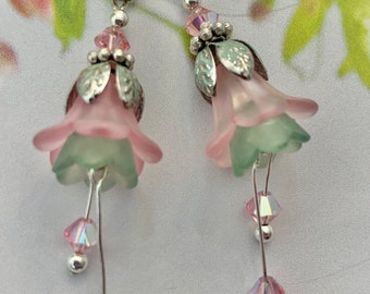 Flower Earrings. Frosted Pink and Green lucite. Genuine Swarovski Pink Crystals. Silver plated Ear Wires and Components. Measure 2”