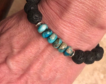 Lava Rock and Turquoise Jasper Bracelet. Strung in Black Stretch Cord. Silver spacers accent Jasper Beads. Sizes to any specification.