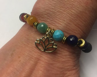 Aromatherapy Chakra Bracelet. Genuine Gemstones and Lava Rock. 24 k Gold plated Lotus charm. Black Cord that adjusts in size to 10 inches.