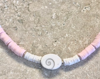 Puca Shell Necklace with pink silicone and tiny silver beads. White swirl Shell pendant. Necklace measures 15.5” with a 2.5” extension chain