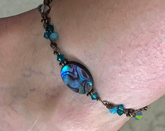 Anklet Abalone Shell. Swarovski Crystal beads and antique gold spacers. Brown cord hand knotted with macrame. Size adjusts from 6.5-12”.