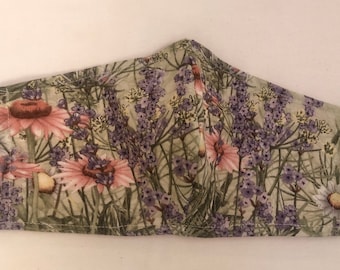 Protective Facial Mask. Wild Flowers Design. Nose Wire and Inner Pocket for Filter. Ear Elastic adjusts for good size and comfort. Washable.