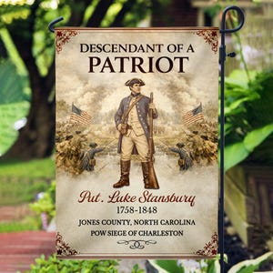 May include: A garden flag featuring a historical illustration of a soldier with a rifle, the text "Descendant of a Patriot," and the name "Put. Luke Stansbury" with dates and location details. The flag is designed for outdoor display.