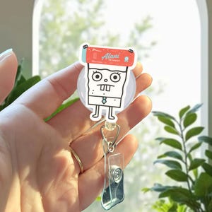 キュートで面白いキャラクターのバッジリールホルダー、引き込み式ナースIDクリップ、医療従事者やオフィススタッフ向けのユニークな医療バッジ