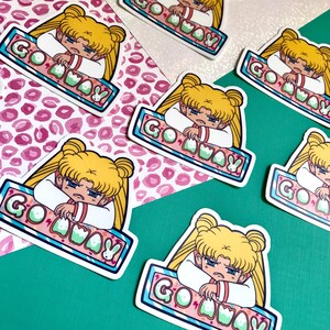 May include: Five colorful stickers featuring a cartoon anime character with blonde hair and a pink and white outfit. The character is saying "Go Away" in a bubble above their head. The stickers are on a pink and green background.