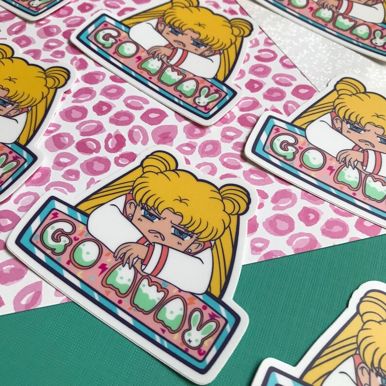 May include: A sticker featuring a cartoon character with yellow hair and a blue and white outfit. The character is sitting on a blue and white striped platform with the text "Go Away" in pink and green letters.