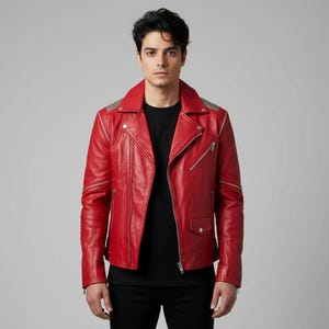 May include: A red leather jacket with a classic biker style. The jacket features a notched collar, asymmetrical zipper closure, and silver-toned hardware. The shoulders have gray accents, and there is a small pocket on the front.