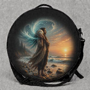 May include: A round black bag featuring a circular print of a person standing on a rocky beach at sunset, holding a large seashell to their ear. The image depicts swirling blue water energy behind the figure, a calm ocean, and a golden sun.