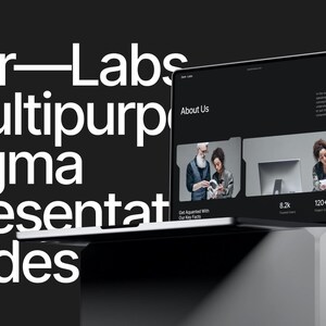 May include: A laptop computer displaying a website with the text "About Us" and a photo of three people working together. The website also includes the text "Get Acquainted with Our Key Facts" and some statistics. The laptop is on a white surface.