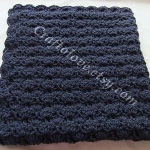 May include: A navy blue crocheted baby blanket with a scalloped edge.