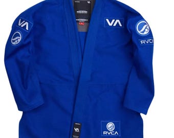 May include: A blue jiu-jitsu gi with white embroidered logos. The logos include "VA" and "RVCA".