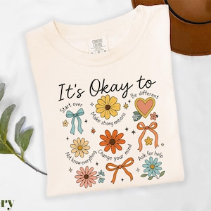 a t - shirt that says it's okay to be different