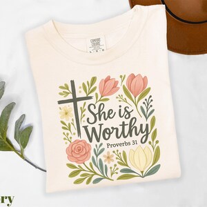 a t - shirt with a cross and flowers on it