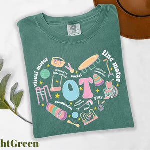 a green t - shirt with a heart shaped design