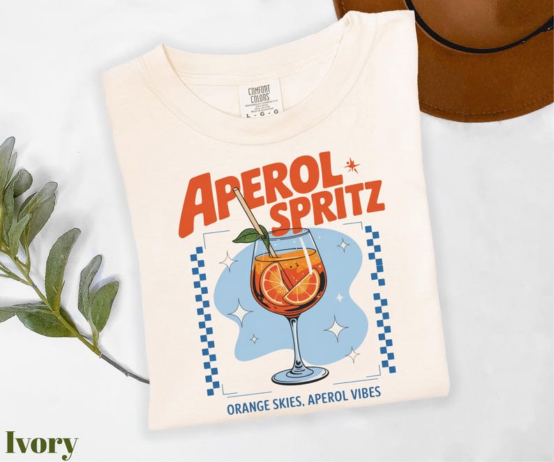 a t - shirt with a picture of an orange drink on it