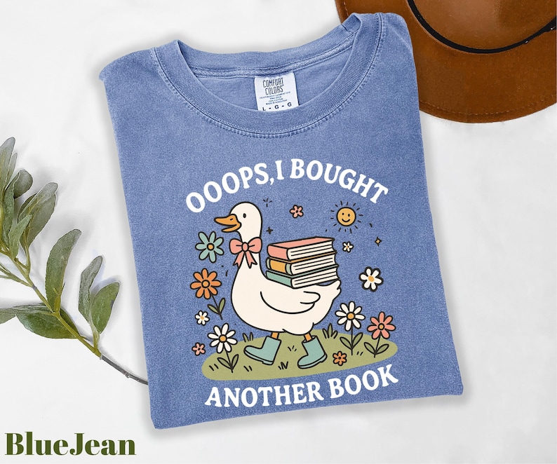 a blue shirt with a duck reading a book