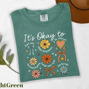 a t - shirt that says it's okay to be different