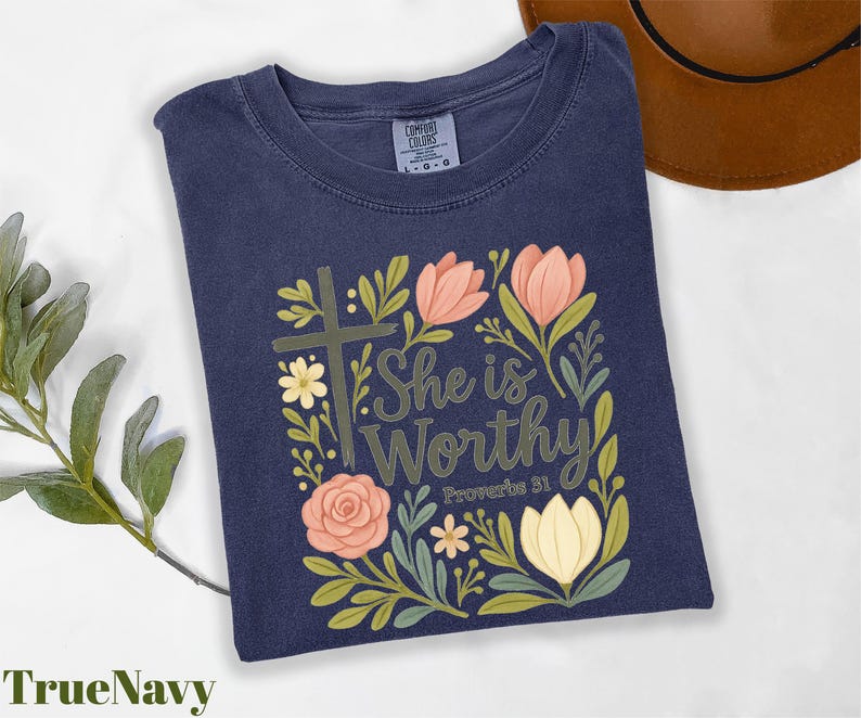 a t - shirt with the words she is worthy surrounded by flowers