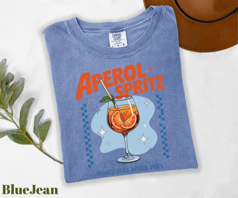 a blue shirt with an orange drink in it