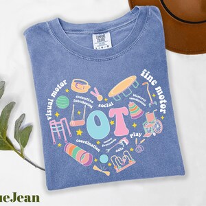 a blue t - shirt with a picture of a heart with the words i love