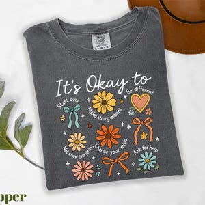 a t - shirt that says it's okay to be different