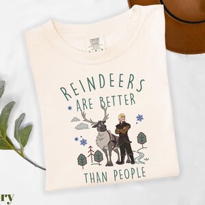 a white t - shirt with reindeers are better than people on it