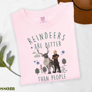 a pink shirt with a picture of a man and a reindeer on it