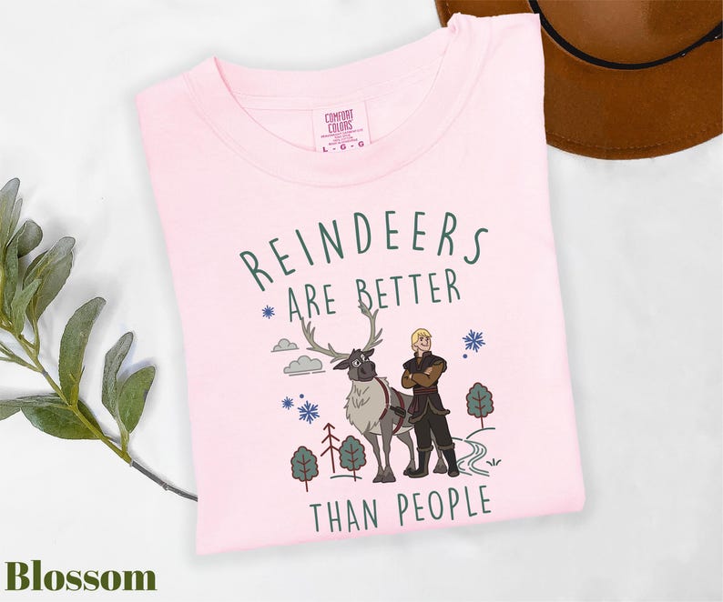 a pink shirt with a picture of a man and a reindeer on it