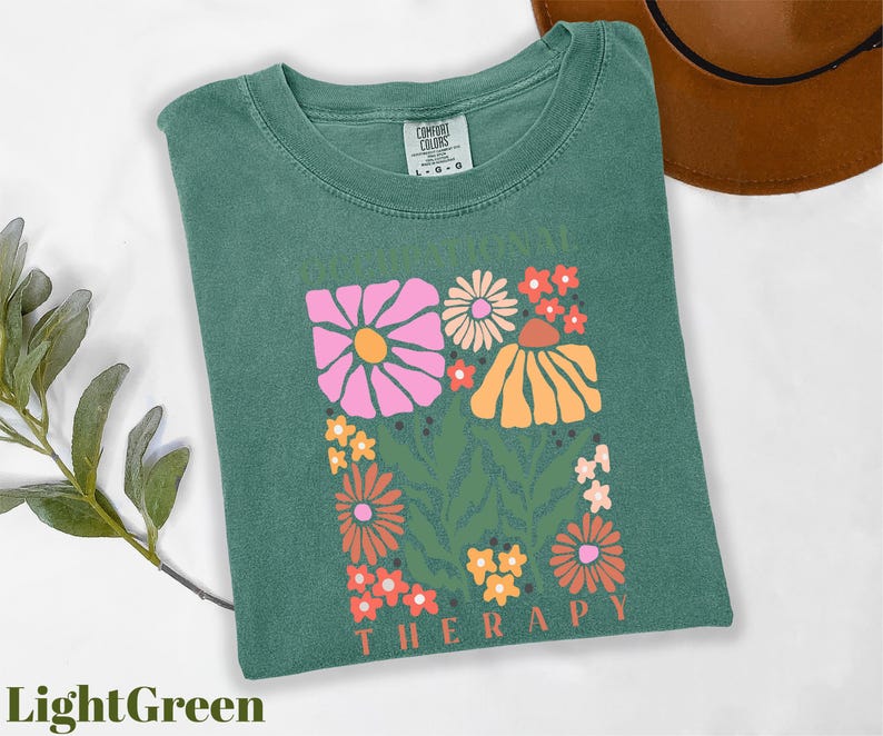 a green t - shirt with a picture of flowers on it