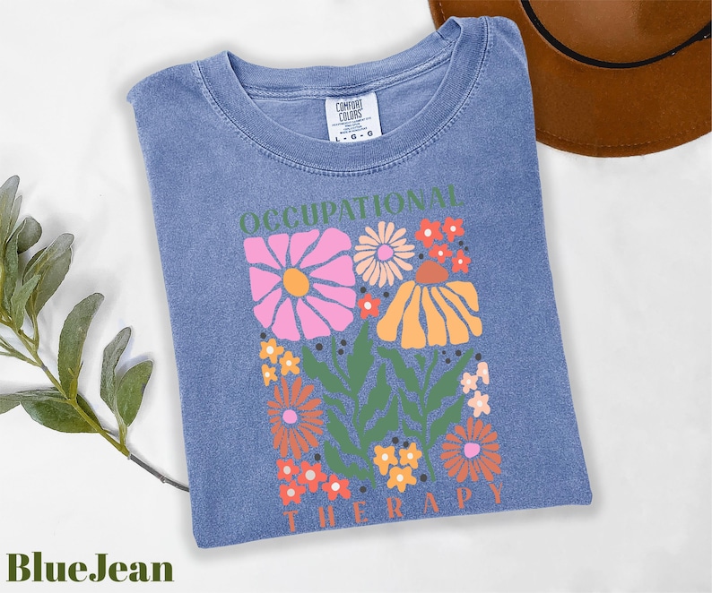 a blue t - shirt with a picture of flowers on it