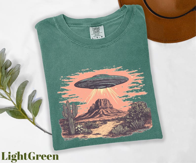 a green shirt with an image of a flying saucer