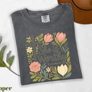 a t - shirt with the words she is worthy on it